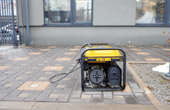 Power supply generator placed on street sidewalk. outdoor diesel power generator in Ukraine.