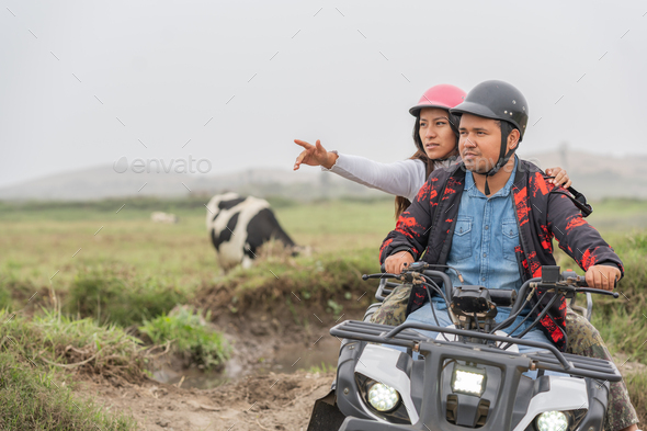 Woman pointing ahead on a quad with a friend