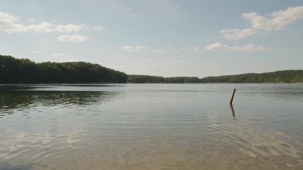Peaceful Lake With Lush Forest Trees Background In Jezioro Glebokie, Poland. Wide Shot alt