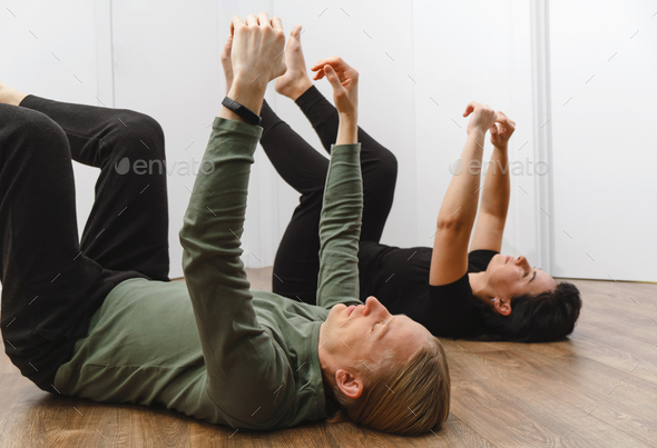 Two people doing relaxation exercise on the floor