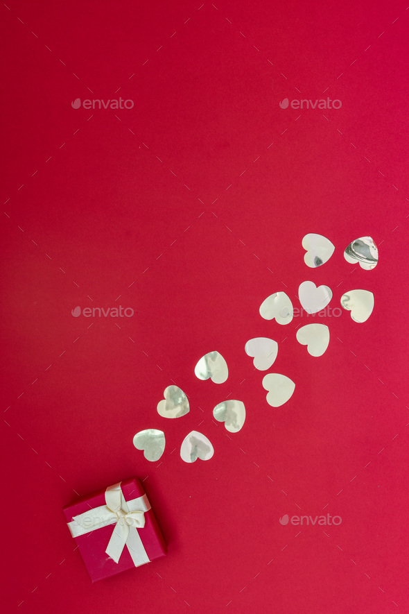 Hearts of paper on red textured background. San Valentine day concept.