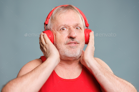 A Man Male Senior Adult Wearing Headphones Amazement Staring In