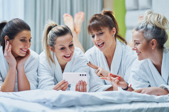 Girls at spa party in hotel with phone