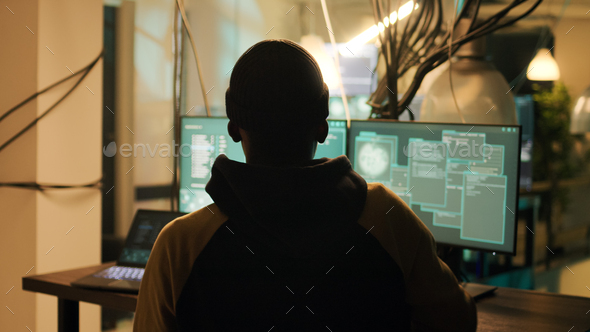 Silhouette of male hacker breaking firewall encryption to plant trojan virus