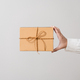 Woman hands holding present box with a ribbon bow. Concept of gift  box minimalist style. - PhotoDune Item for Sale