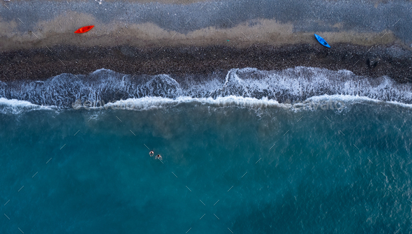 Drone aerial of people swimming in the sea after kayaking. Athletes active. Healthy lifestyle