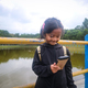 South East Asian girl playing smartphone  - PhotoDune Item for Sale