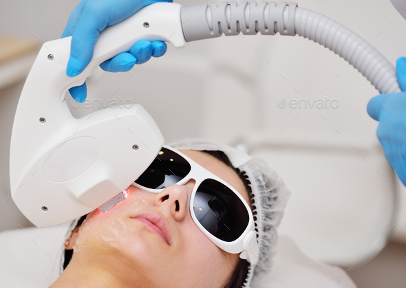 The cosmetologist restores the patient's skin with the help of hardware RF -fractional rejuvenation
