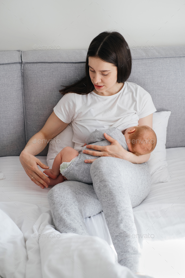 Baby breastfeed and sleep on mothers hands Stock Photo by ninelutsk