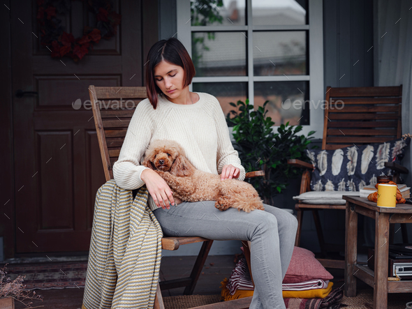 Young beautiful woman resting outdoors with cup of coffee with dog. - Stock Photo - Images