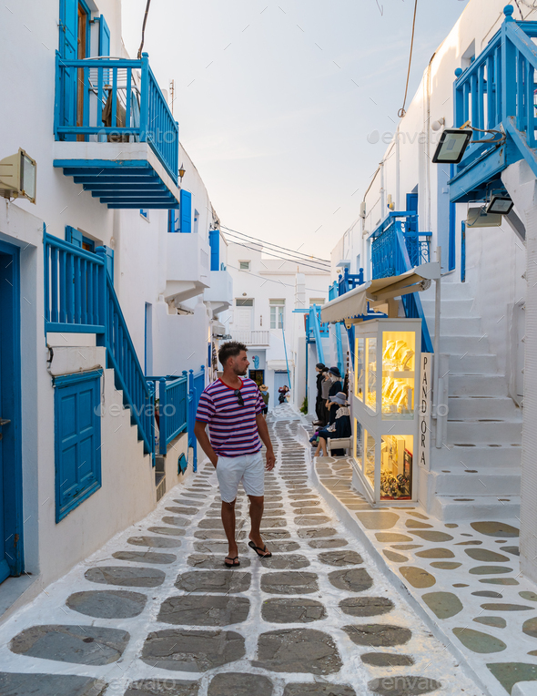 Tourist at the streets of Mykonos Greek village in Greece, colorful ...