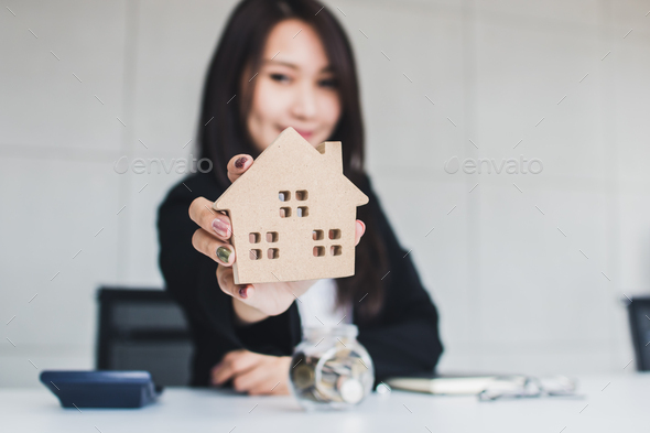 Business woman, Bank agency holding house model and give proposal, housing loan real estate concept