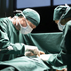 Surgeon operating on patient, team of medical professionals working in operating room. - PhotoDune Item for Sale