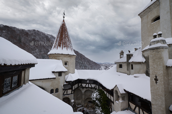 The snow covered medieval Castle of Bran, known for the castle of Dracula. Transylvania. Romania.