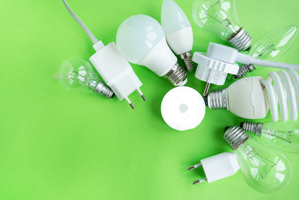 A set of different types of LED lamps isolated on a green background. Energy-saving lamps, in the