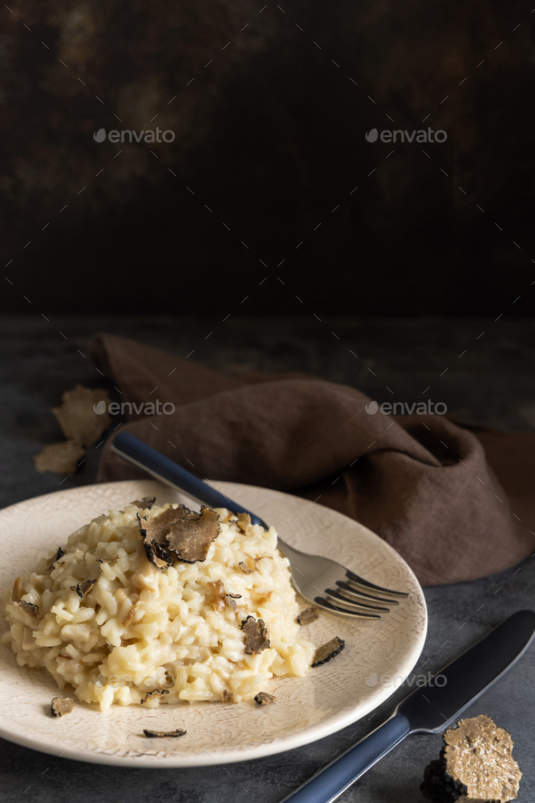 Risotto with porcini mushrooms and black truffles served in a plate top