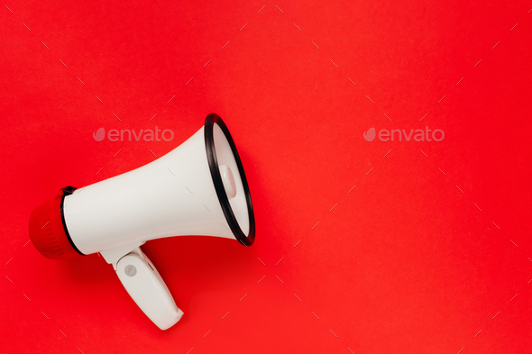 White megaphone on red background. Alarm and announcement - Stock Photo - Images