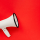White megaphone on red background. Alarm and announcement - PhotoDune Item for Sale