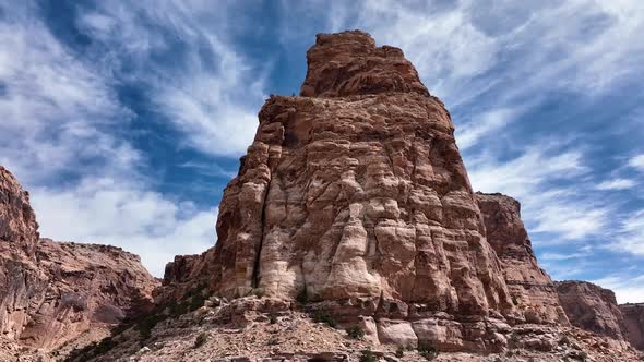 Aerial view rotating around desert canyon cliff in the San Rafael Swell alt