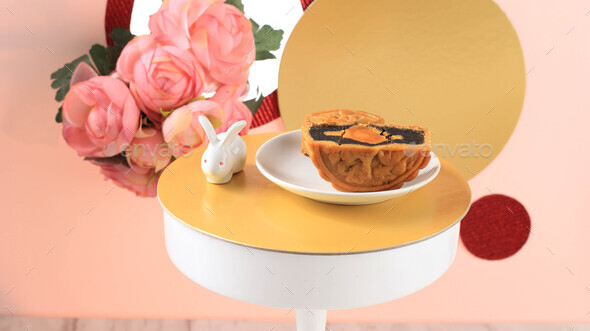 Mooncake on Light Pink Background with Pink Flower. Concept Moon Cake