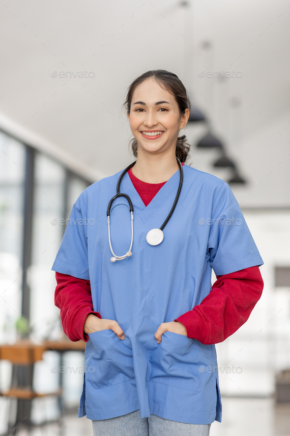 portrait of Cheerful Indian beautiful Asian female doctor posing and smiling at camera, healthcare