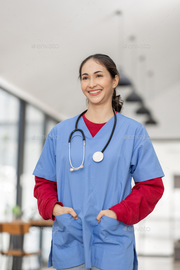 portrait of Cheerful Indian beautiful Asian female doctor posing and smiling at camera, healthcare a