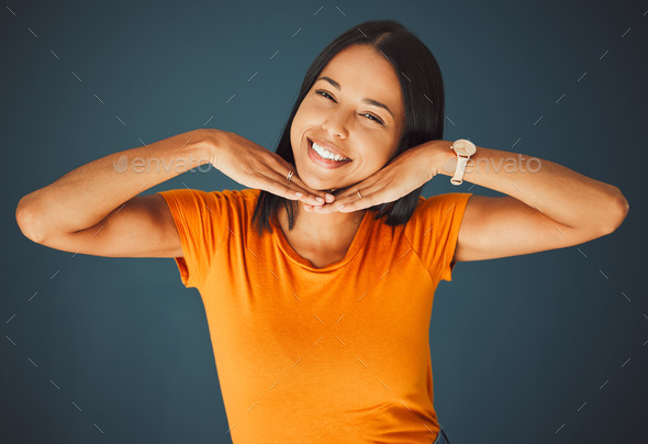 Woman, hands on face and smile portrait in studio for kindness, beauty and  motivation for happiness Stock Photo by YuriArcursPeopleimages