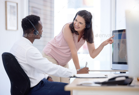 Woman, consulting and pointing at computer in call center job for help, coaching or advice for dive