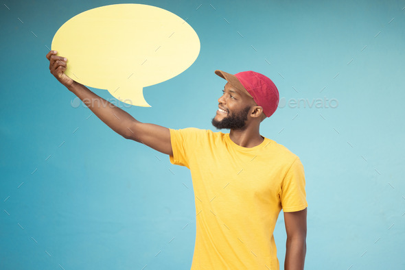 Speech bubble, advertising and black man on blue background for announcement, news and information.