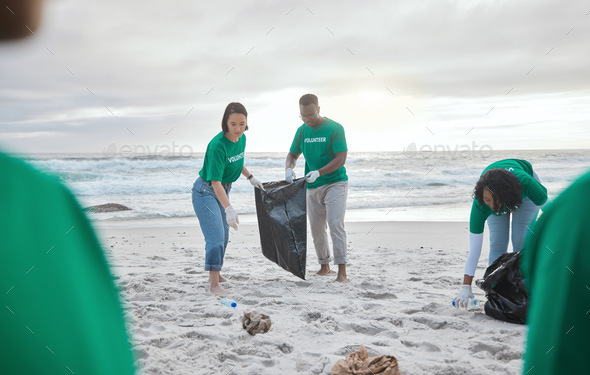 Teamwork, charity and recycling with people on beach for sustainability ...