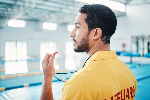 Lifeguard, whistle and swimming pool safety by man watching at indoor facility for training, swim a