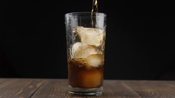 Pouring coke/cola/soda into a glass