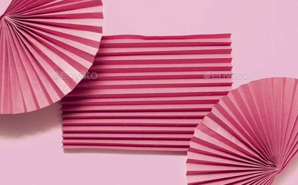 Pink circle handmade paper fans on pink background. Chinese New Year 2023 background