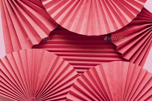 Pink circle handmade paper fans on pink background. Chinese New Year 2023 background