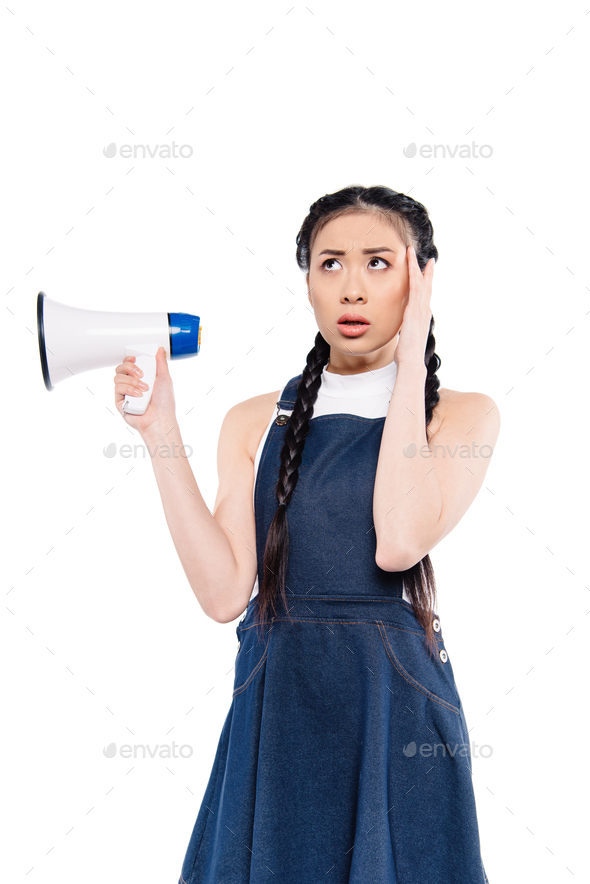 portrait of confused asian woman with loudspeaker isolated on white