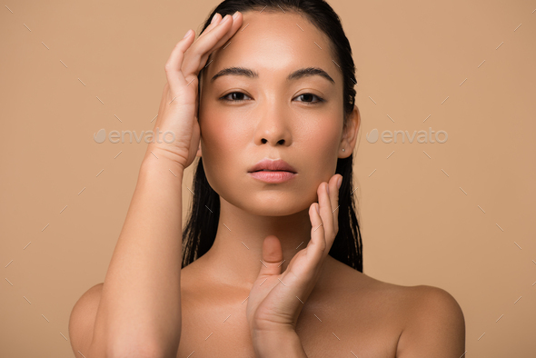 590px x 394px - beautiful naked asian girl touching face isolated on beige Stock Photo by  LightFieldStudios
