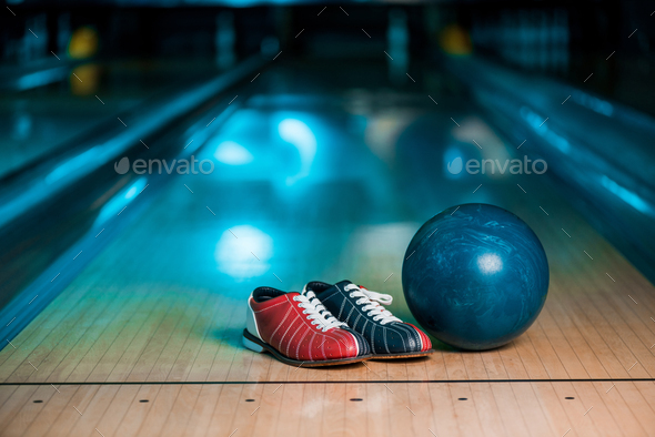 selective focus of bowling shoes, balls and skittle on skittle