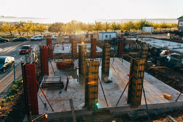 Construction site with steel formworks and reinforcing bars for pillars ready for concrete - Stock Photo - Images