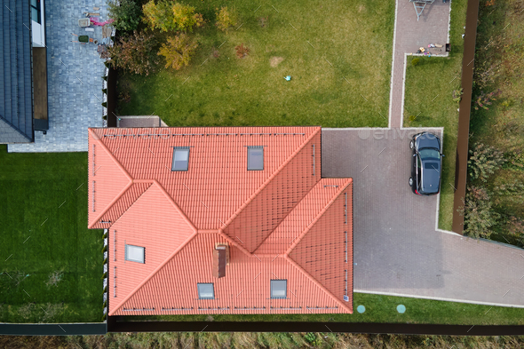 Aerial view of private house with ceramic shingles covered roof top.