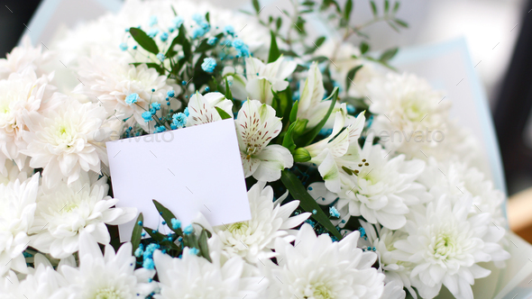 bouquet of different flowers and a empty gift card, place for your text - Stock Photo - Images