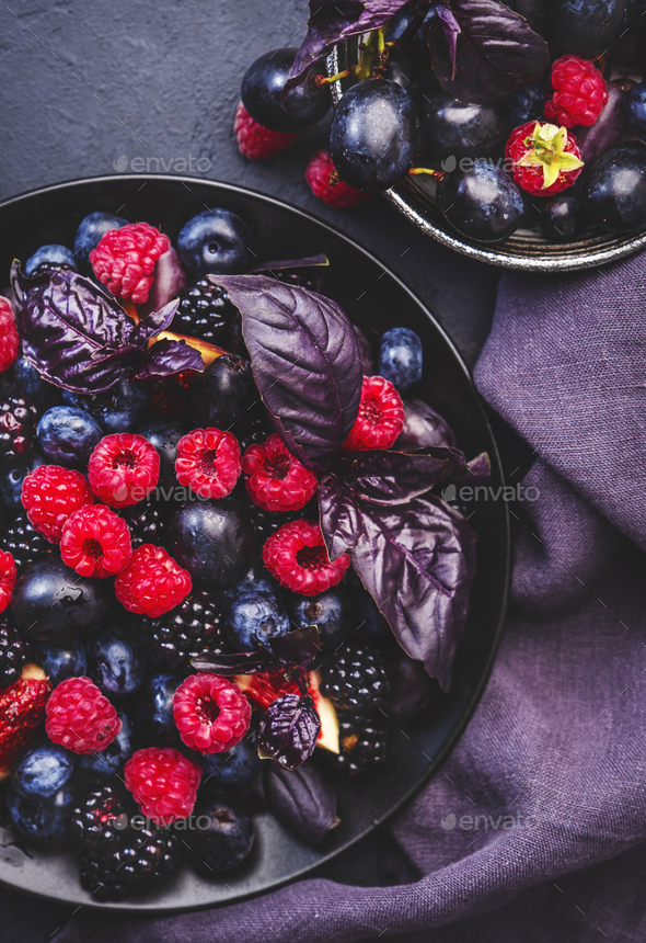 Summer blue and black berries fruit vegan salad: blueberries, blackberries, grapes, figs and basil