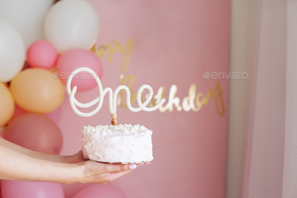 birthday cake with cream and flowers on a white background. Celebrating first year of birth.