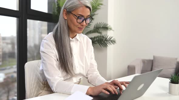 Smart Mature Woman Entrepreneur Looking Through Emails alt