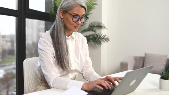 Smart Mature Woman Entrepreneur Looking Through Emails