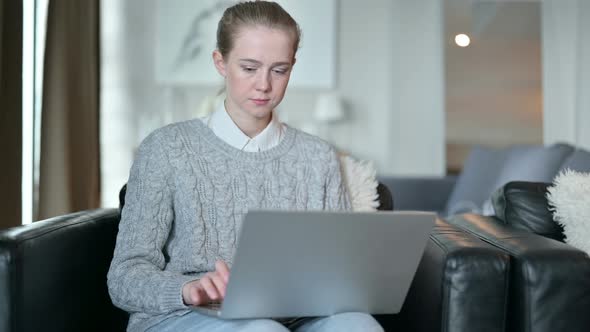 Serious Young Woman Working From Home on Laptop  alt