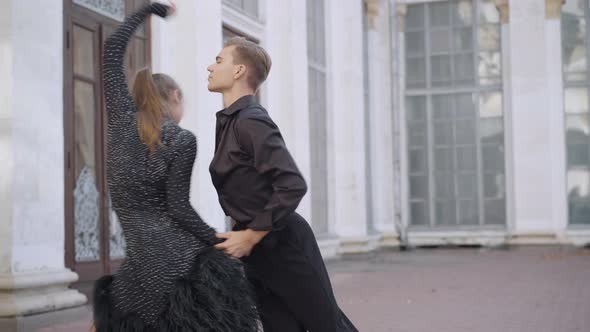Live Camera Follows Talented Young Couple of Dancers Performing Latin Ballroom Dance in Urban City alt
