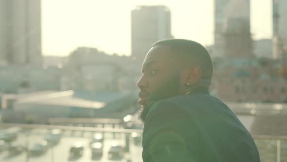 Smiling African Businessman Dancing at Street. Male Worker Looking at Camera alt