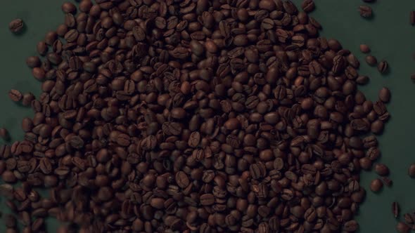 Roasted Arabica Coffee Beans are Poured on the Table alt