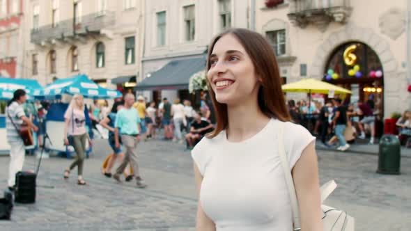 Girl Walking in City in Evening