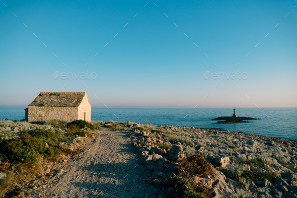 Country road to the old stone church of St. Ivan at cape Punta Planca